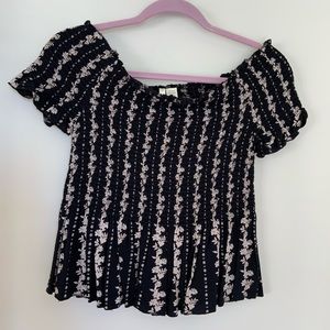 Off the shoulder ruched black floral crop top.